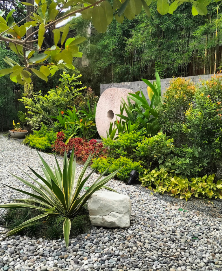 Tranquil Zen garden featuring lush greenery, natural stone elements, and a peaceful outdoor sanctuary with bamboo landscaping.
